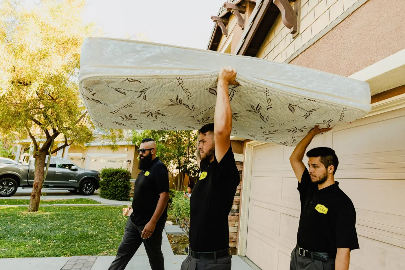 Team carrying a mattress to the truck