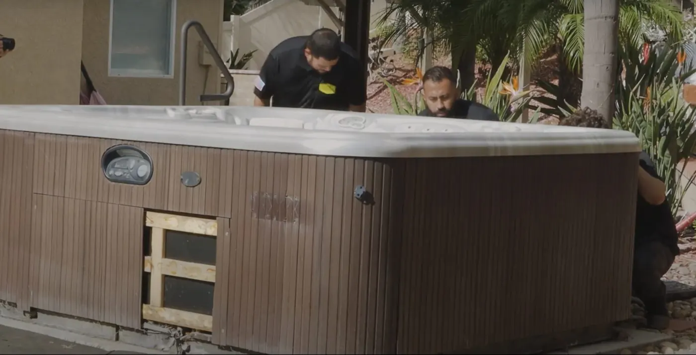 Team removing an old hot tub